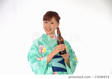 A woman with a young yukata with a beer bottle smiling A woman with a young yukata with a beer bottle smiling 15896854