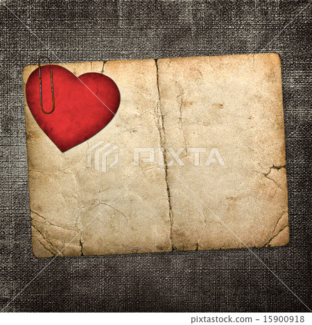 old paperboard card with red paper heart on a dark fabric backgr 15900918