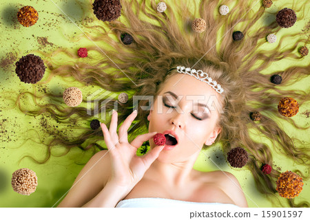 Woman eating candies Woman eating candies 15901597
