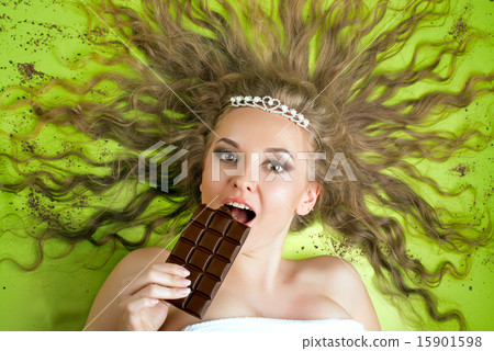 Attractive woman eating chocolate Attractive woman eating chocolate 15901598