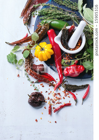 Assortment of chili peppers and herbs 15905316