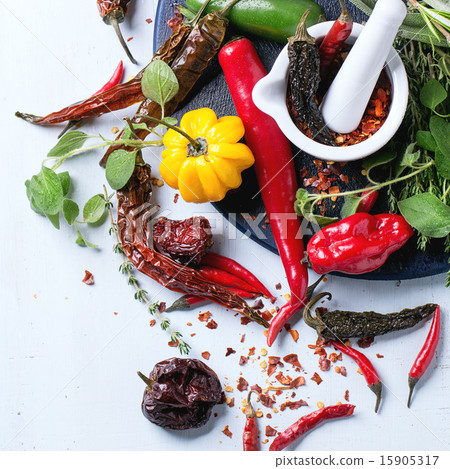 Assortment of chili peppers and herbs 15905317