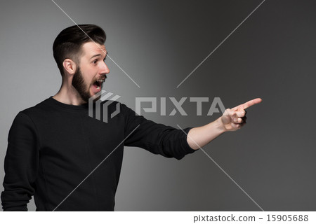 Excited man pointing a great idea - over gray background Excited man pointing a great idea - over gray background 15905688