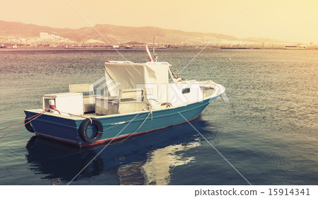 Old wooden pleasure boat anchored in Izmir bay Old wooden pleasure boat anchored in Izmir bay 15914341