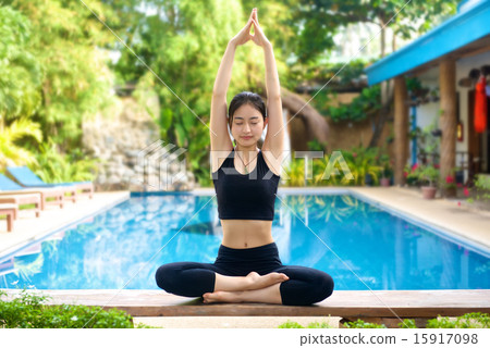 Asian Girl practicing yoga on a bench 15917098