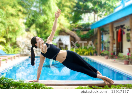 Asian Girl practicing yoga on a bench Asian Girl practicing yoga on a bench 15917157