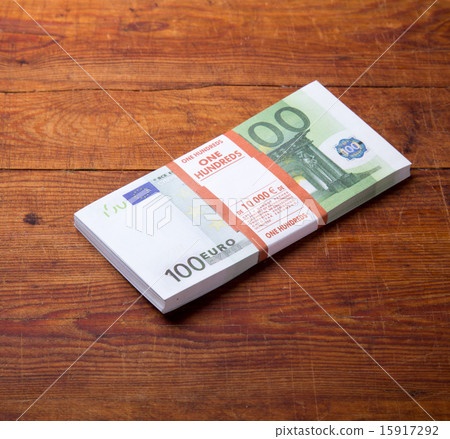 Close-up of  100 Euro banknotes on wood background 15917292