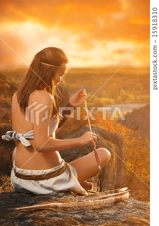 Primitive woman  holding a bow and arrow. Amazon woman 15918310