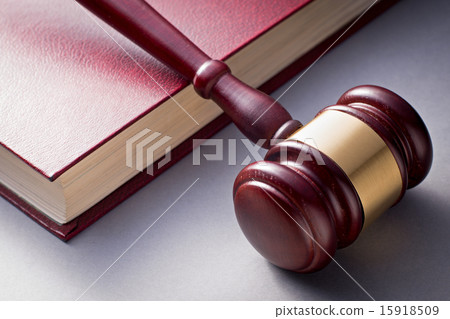 Wooden Gavel Resting on Red Leather Book Wooden Gavel Resting on Red Leather Book 15918509