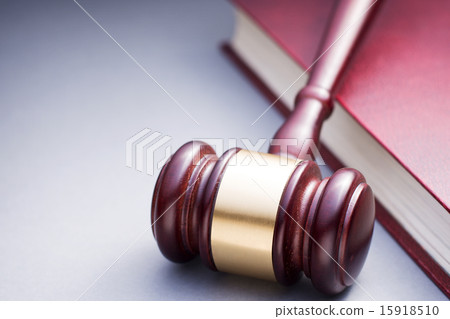 Wooden Gavel Resting on Red Leather Book Wooden Gavel Resting on Red Leather Book 15918510