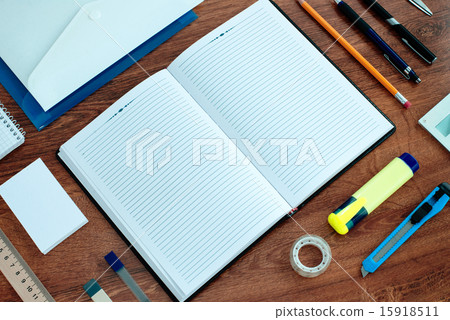 Office Supplies Arranged Around Notebook on Desk Office Supplies Arranged Around Notebook on Desk 15918511