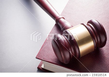 Wooden Gavel Resting on Red Leather Book Wooden Gavel Resting on Red Leather Book 15918514