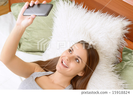 Young woman skyping on phone at home. Young woman skyping on phone at home. 15918824