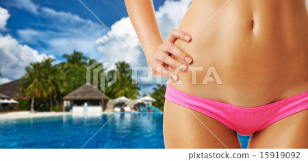 Woman at tropical swimming pool 15919092