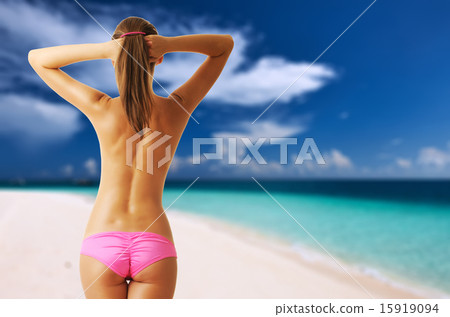 Woman topless on tropical beach at Maldives 15919094
