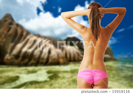 Woman topless on beautiful beach at Seychelles 15919116