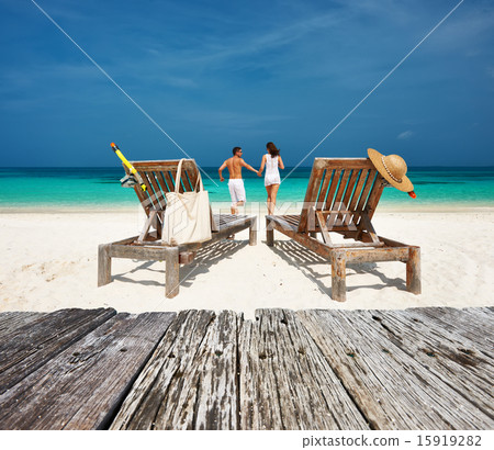Couple in white relax on a beach at Maldives 15919282