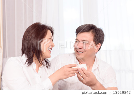 Smiling Asian family drinking tea Smiling Asian family drinking tea 15919842