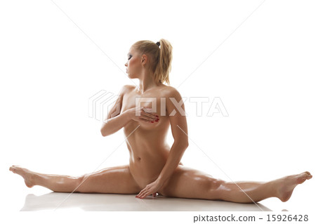 Stretching. Nude sweaty girl doing gymnastic split 15926428