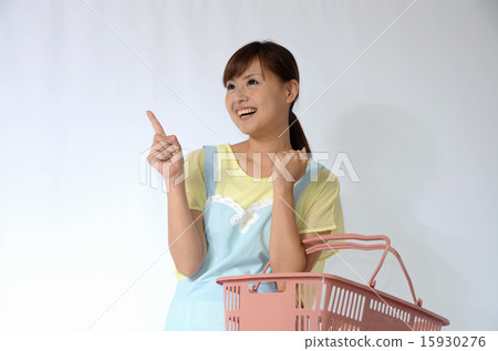A young woman in an apron with a shopping basket 15930276