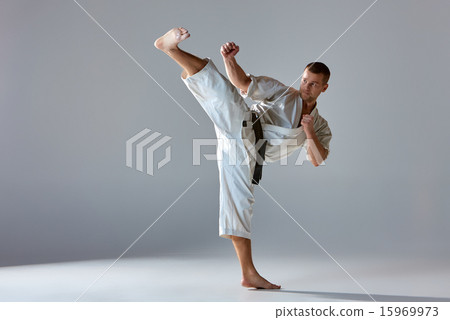 Man in white kimono training karate 15969973