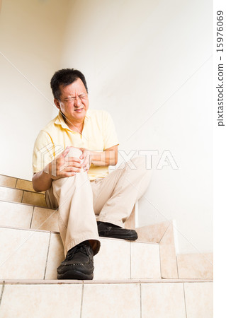 Man suffering painful knee joint rest on steps 15976069