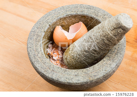 Kitchen mortar and pestle with crashed egg shell Kitchen mortar and pestle with crashed egg shell 15976228