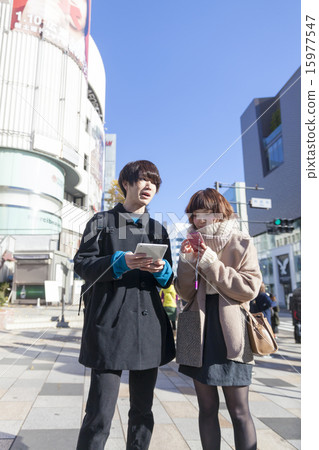 Talk with a couple smartphone and tablet Harajuku Raffaele in front Talk with a couple smartphone and tablet Harajuku Raffaele in front 15977547