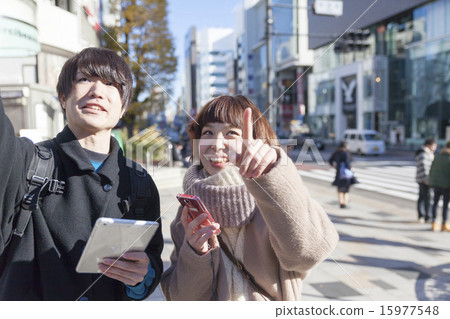 Having a couple smartphone and tablet looking for images of shops Harajuku Laforet Front Having a couple smartphone and tablet looking for images of shops Harajuku Laforet Front 15977548
