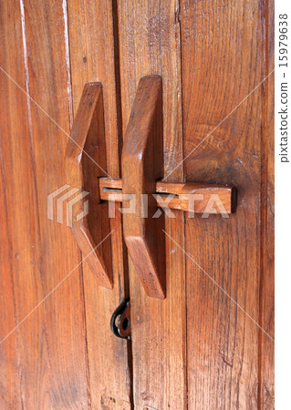 Door handle on brown wood door 15979638