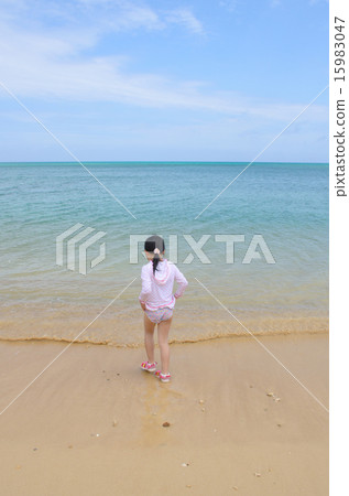 Girls standing on the beach Girls standing on the beach 15983047