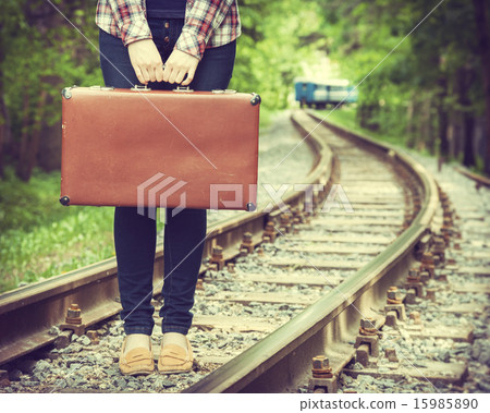 young woman with old suitcase on railway young woman with old suitcase on railway 15985890