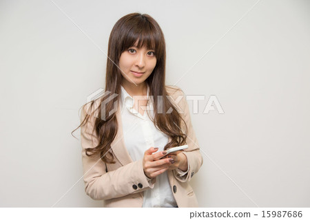 A young woman operating a phone A young woman operating a phone 15987686