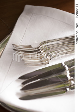 Knifes and forks on white napkin in party 15988311