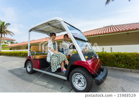Two women riding a cart Two women riding a cart 15988529