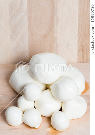 balls mozzarella different size on wood background 15990750