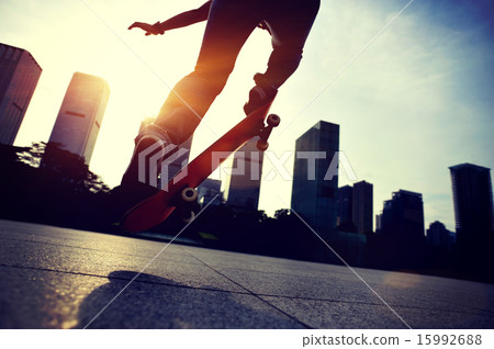 skateboarder doing skateboarding trick ollie on sunrise city 15992688