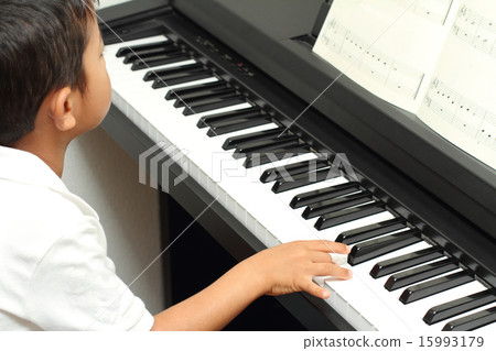Children's hand playing the piano Children's hand playing the piano 15993179