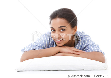 Smiling lying mulatto girl on pillow Smiling lying mulatto girl on pillow 15994792