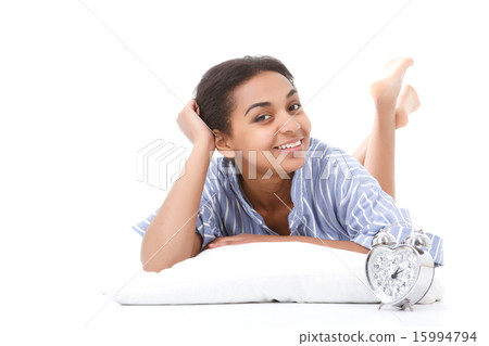 Smiling lying mulatto girl on pillow  15994794
