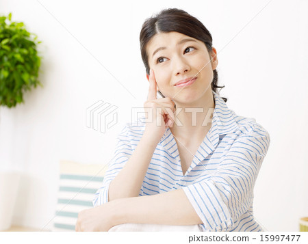 A woman thinking in a room 15997477