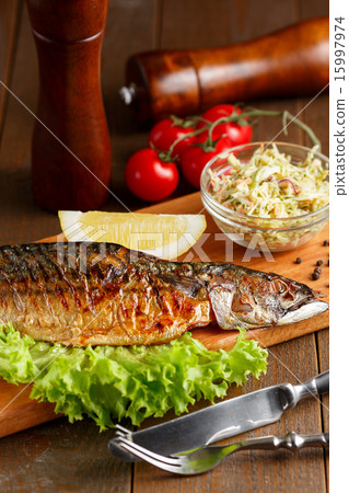 Fried mackerel with slice of lemon and lettuce Fried mackerel with slice of lemon and lettuce 15997974