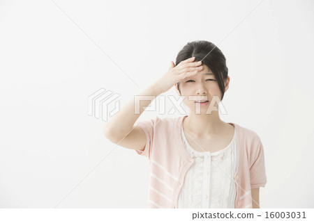A woman holding a headache head A woman holding a headache head 16003031