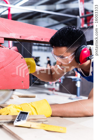 Carpenter in Asian workshop with circular saw Carpenter in Asian workshop with circular saw 16003333