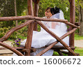 Couple love bride and groom posing sitting on wood 16006672