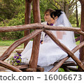 Couple love bride and groom posing sitting on wood 16006673