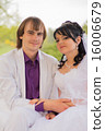 Couple love bride and groom posing sitting on wood 16006679