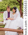 Couple love bride and groom posing sitting on wood 16006683