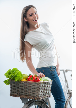 Cheerful young lady with vegetables and fruits Cheerful young lady with vegetables and fruits 16007674