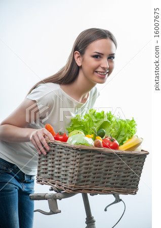 Pretty woman is standing with vegetarian food Pretty woman is standing with vegetarian food 16007675